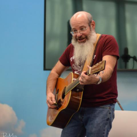 David Landau playing his guitar during a performance