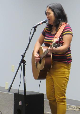 A woman is playing a guitar